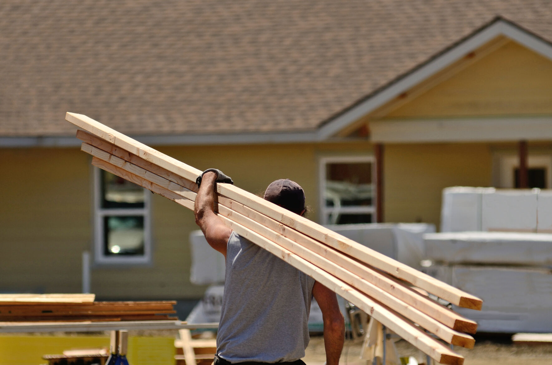 Home builder carrying wood stock